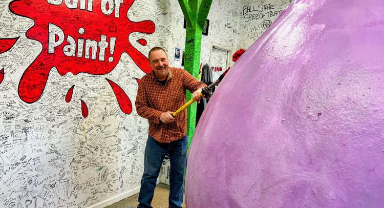 Scott applying a coat to the World's Largest Ball of Paint.